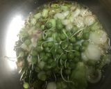A picture of step 3 of Baingan bharta with green peas.