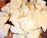 A picture of step 3 of Pork chops with potatoes in the oven.