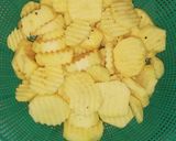 A picture of step 1 of Seasoned potatoes, kachumbari & pork sausages.
