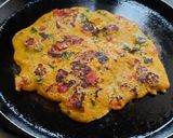 A picture of step 7 of Besan onion tomato chilla.
