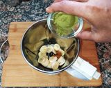 A picture of step 2 of Banana Moringa Yakult Milkshake topped with Walnuts.