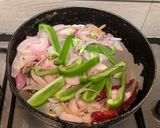 A picture of step 4 of Paneer Jalfrezi with steamed white rice.