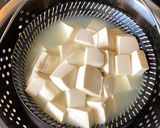 A picture of step 7 of Steamed tofu with sweet soy dressing sauce and spring onions.