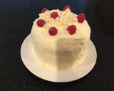 A picture of step 14 of Vanilla Layer Cake filled withLenon and Rasberry and frosted with Fresh Lemon Cream.