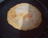 A picture of step 5 of Rava Uttapam with veggies, packed with fruits and dryfruits.