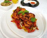 A picture of step 4 of Pan Fried Chicken Breast on a bed of Pepper's and Onion.