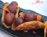 A picture of step 23 of Warm gulab jamun in sweet crunchy tacos.
