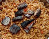 A picture of step 7 of Jollof macaroni with fried boneless fish.