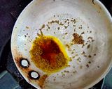 A picture of step 2 of Tomato Raita seasoned with Mustard seeds.