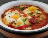 A picture of step 9 of Saganaki with Country Sausage, Eggs, and Graviera Cheese.