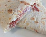 A picture of step 3 of Speck, brie and red onion piadina.