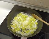 A picture of step 1 of Garlic Soup with Caramelized Onion, Leek, and Goat Cheese.