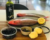 A picture of step 1 of Whole Baked Fish with potatoes and olives.