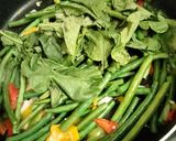 A picture of step 2 of Fried Green Beans with Ham & Radish Greens.
