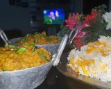 A picture of step 7 of Dam allu with colourful zeera rice.
