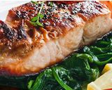 A picture of step 4 of Salmon with thyme on bed of spinach.
