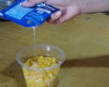 A picture of step 2 of Jasuke (Sweet Corn with milk and cheese/chocolate).