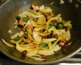 A picture of step 2 of Upma with puffed rice and colorful veggies.