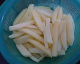A picture of step 2 of Dynamite cheese loaded fries.