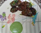 A picture of step 8 of Homemade crispy Patra with some spicy green chutney.