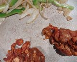 A picture of step 2 of Pork Al pastor with sauteed onions and peppers.