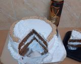 A picture of step 7 of Chocolate Guinness cake with whipped cream icing.