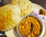 A picture of step 7 of Masala poori with white chana.