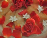 A picture of step 3 of Peach mousse, red roses and white flowers bouquet.