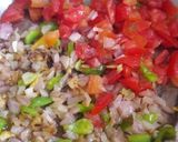 A picture of step 7 of Moong dal khichdi with onion tomato and capsicum tadka.