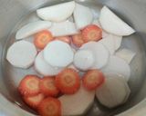 A picture of step 1 of Mooli Gajar Shalgam Kadhi.