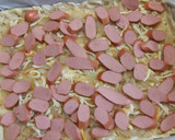 Foto del paso 5 de la receta: Hojaldrado de salchichas y cebollitas