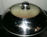A picture of step 5 of Aaloo bangan with white rice.
