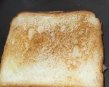 A picture of step 2 of 3 layered cheese sandwich.