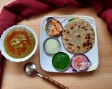 A picture of step 4 of Bajra Roti with saag/Jaggery/chutney.