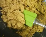 A picture of step 4 of Besan laddoo with sunflower and flax seeds.