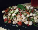 A picture of step 5 of Healthy Makhaana Salad with fruits veggies and nuts.