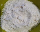 A picture of step 1 of Coconut fritters deep in sugar syrup.