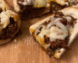 A picture of step 3 of Sloppy joes stuffed french bread.