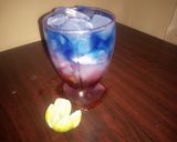 A picture of step 2 of Sunrise moctail and layered blue paradise.