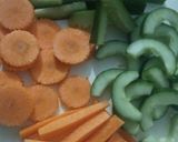 A picture of step 1 of Pickled cucumber & carrot accompanied with freshgreen & red chillies.