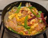 A picture of step 7 of Paneer Jalfrezi with steamed white rice.