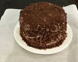 A picture of step 28 of Chocolate Layer Cake with Strawberry Cream Filling, White Chocolate Ganache Frosting coated with a Chocolate Crumble.
