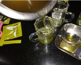 A picture of step 6 of Honey and mint iced green tea shots.