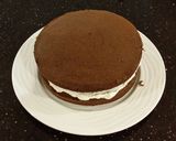 A picture of step 16 of Mocha Layer Cake with Whipped Mascarpone Cream and a Coffee Glaze Drizzle.