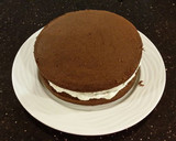 A picture of step 16 of Mocha Layer Cake with Whipped Mascarpone Cream and a Coffee Glaze Drizzle.