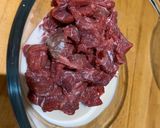 A picture of step 1 of Beef and grilled aubergine red curry topped with Bird eye chillis.