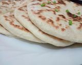 A picture of step 6 of Sweet Potato Curry and peas served with naan bread.