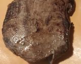A picture of step 3 of Flank Steak on a bed of Onions.