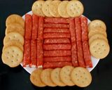 A picture of step 5 of My cheese wrapped in Pepperoni and Savoury Crackers 🤩.
