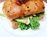 A picture of step 1 of Subway style sandwich with raw mango slice.